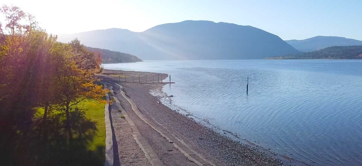 Shuswap Lake at first light, looking along the shoreline toward the hills